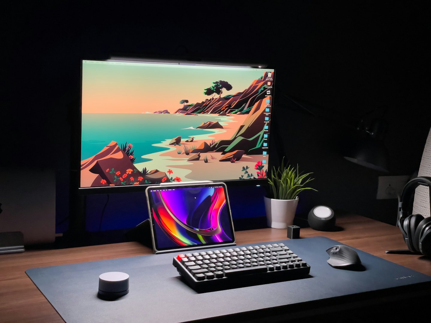 A modern wooden desk with a computer monitor and accessories.